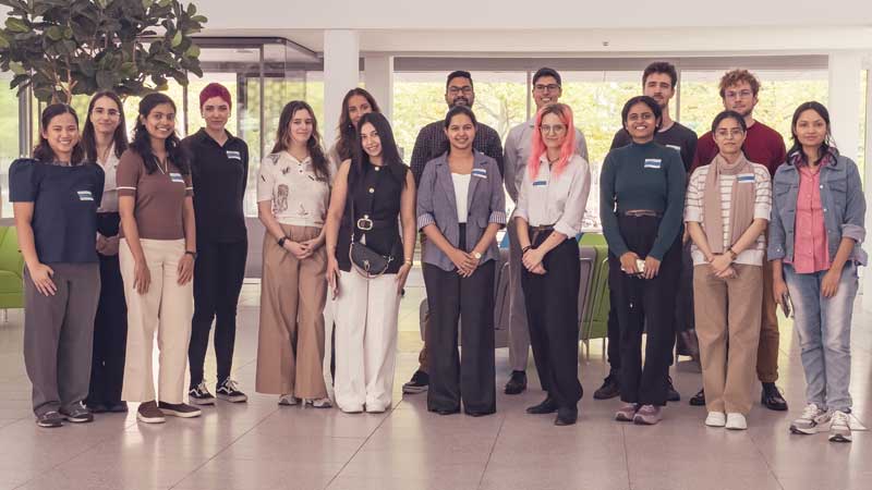 16 people grouping for a photo shoot in the atrium of a modern scientific institute